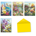 Assortment of four nature-themed greeting cards featuring hummingbirds and vibrant flowers (narcissus, iris, orchids) with a bright yellow envelope.
