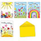 Collection of four open religious greeting cards and one bright yellow envelope. Cards feature watercolor art: a sunny 'Let your light shine' card with flowers, a 'God Bless You On Your Birthday' card with hearts and flowers, a 'Keep Looking Up' card with a rainbow and flowers, and a 'May LORD the smile on you' card with sun and hearts.