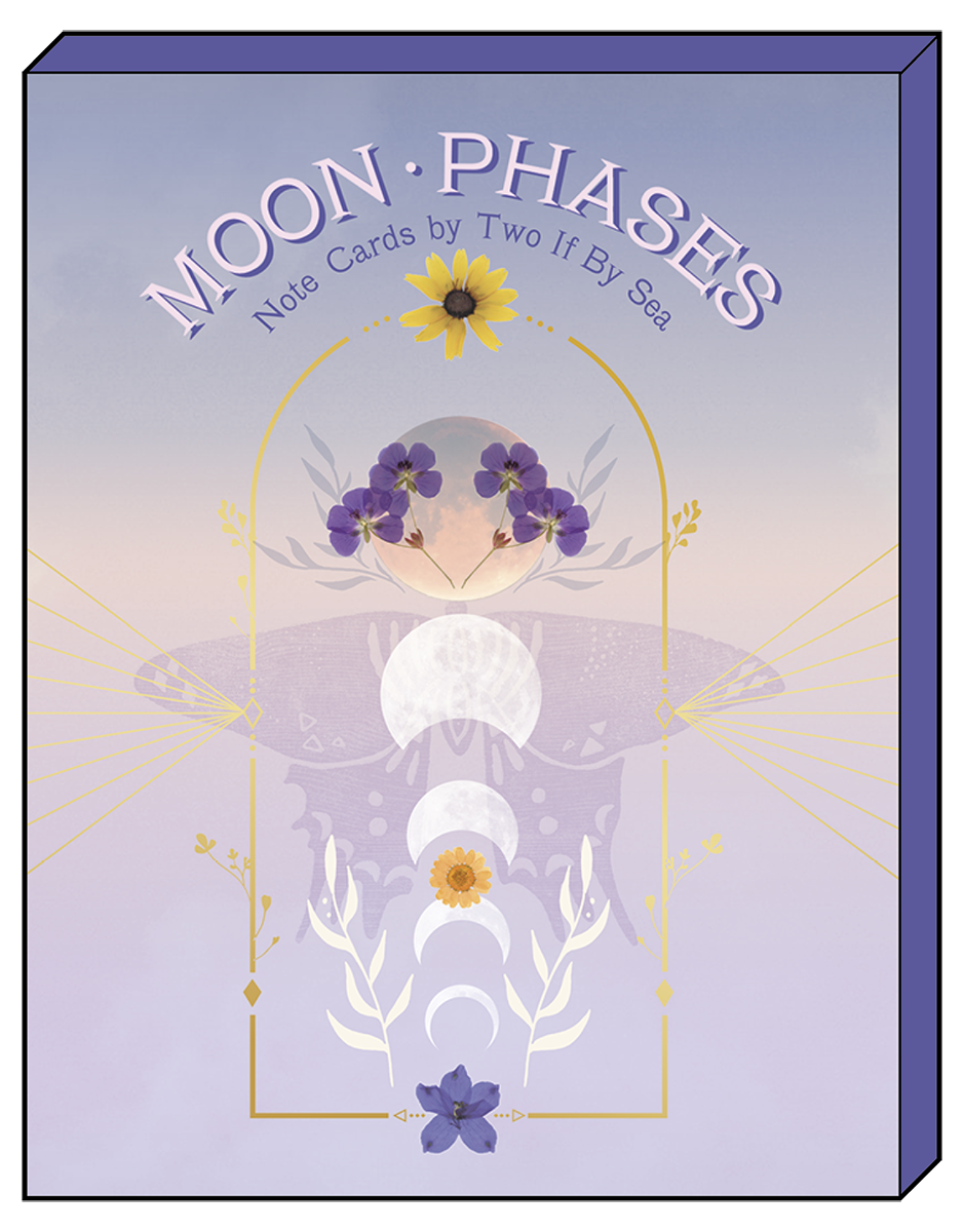 Close-up of a 'Moon Phases Note Cards by Two If By Sea' greeting card featuring a purple, orange, and white moon phase design with flowers and gold accents.