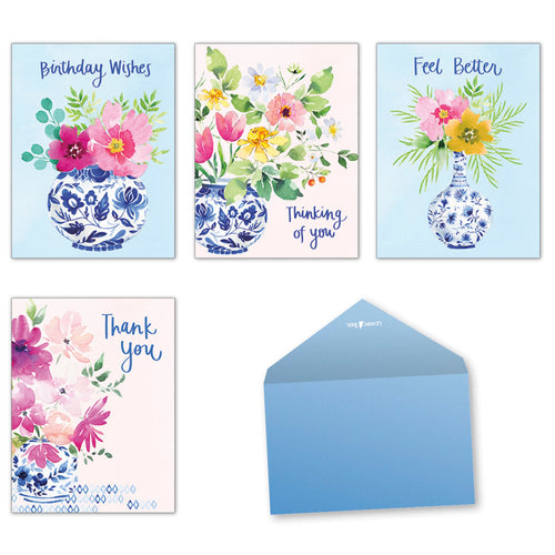 Assortment of four watercolor floral greeting cards featuring blue and white chinoiserie vases, vibrant pink and yellow flowers, with a light blue envelope.