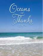 Elegant thank you card featuring 'Oceans of Thanks' script over a serene blue ocean with gentle waves and sandy beach, perfect for expressing deep gratitude.
