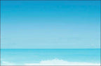 Calm blue ocean horizon with a distant wave breaking, representing peace and vast appreciation.