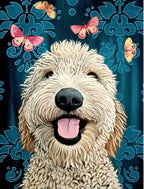 Close-up of a smiling fluffy golden doodle dog with its tongue playfully out, surrounded by vibrant pink and yellow butterflies against a dark blue damask-like patterned background. SEO for cute dog greeting cards.