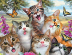 Close-up of six happy, playful kittens with vibrant fur colors (tabby, orange, white, grey) sticking out tongues, surrounded by colorful butterflies and lush green foliage with pink and purple flowers against a bright sky.