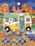 Whimsical watercolor illustration of a yellow camper van parked in a desert landscape under a starry night sky. The scene features cacti, red rock formations, a full moon, a campfire table with playing cards, a sleeping dog, a cat, and a guitar, perfect for nature-loving card recipients.