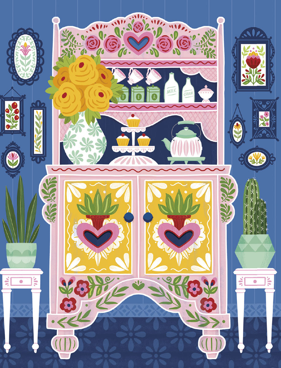 Vibrant folk art inspired greeting card design featuring a decorative pink and yellow hutch filled with yellow roses, cupcakes, and a tea set, surrounded by framed botanical prints and potted plants. Perfect for sending cheerful notes.