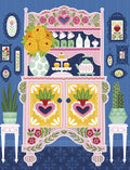 Vibrant folk art inspired greeting card design featuring a decorative pink and yellow hutch filled with yellow roses, cupcakes, and a tea set, surrounded by framed botanical prints and potted plants. Perfect for sending cheerful notes.