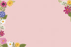 Soft pink background with elegant borders of assorted colorful wildflowers and green leaves, ideal for custom messages inside a greeting card.