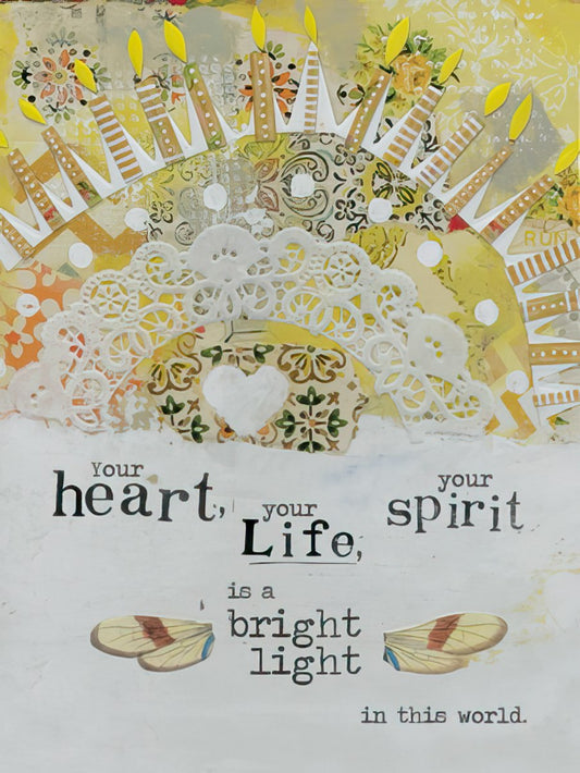 Birthday card featuring a mixed-media design with yellow and white tones, candles, lace, and butterfly wings, with the text 'Your heart, your spirit, your Life, is a bright light in this world.'
