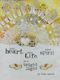 Abstract collage greeting card front with illuminated candles, a white lace doily motif, and the heartfelt quote 'Your heart, your life, your spirit is a bright light in this world.' against a yellow and cream patterned background.