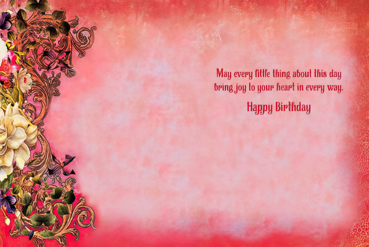 Inside view of a heartfelt birthday greeting card, displaying a delicate light pink background with a floral and gold ornate border on the left, and the sentiment: 'May every little thing about this day bring joy to your heart in every way. Happy Birthday' in a warm red font on the right.
