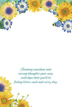 Inside of an encouraging greeting card with yellow sunflowers, blue daisies, and white flowers, displaying a heartfelt message: 'Sending sunshine and caring thoughts your way, with hope that you'll be feeling better each and every day.'