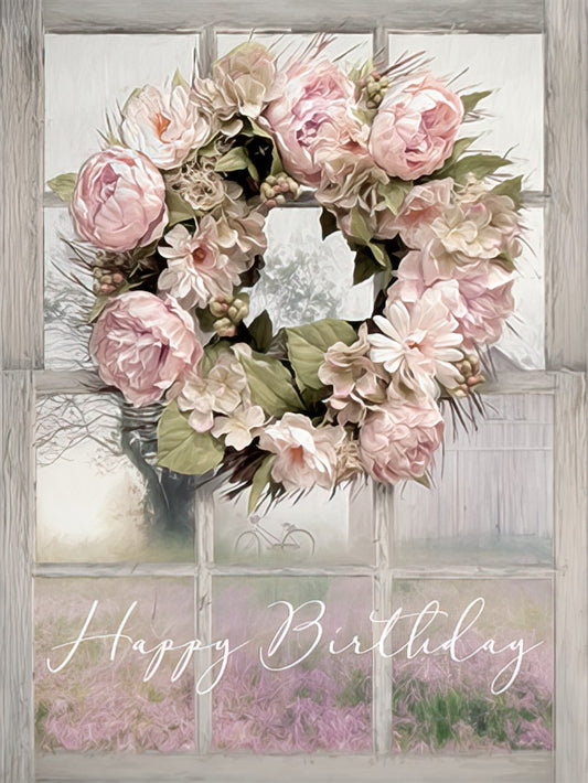 Elegant pink floral wreath with peonies and hydrangeas hanging on a rustic white window frame, displaying 'Happy Birthday'.