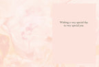 Inside view of a heartfelt greeting card with a soft pink floral background, displaying the warm message 'Wishing a very special day to very special you.'