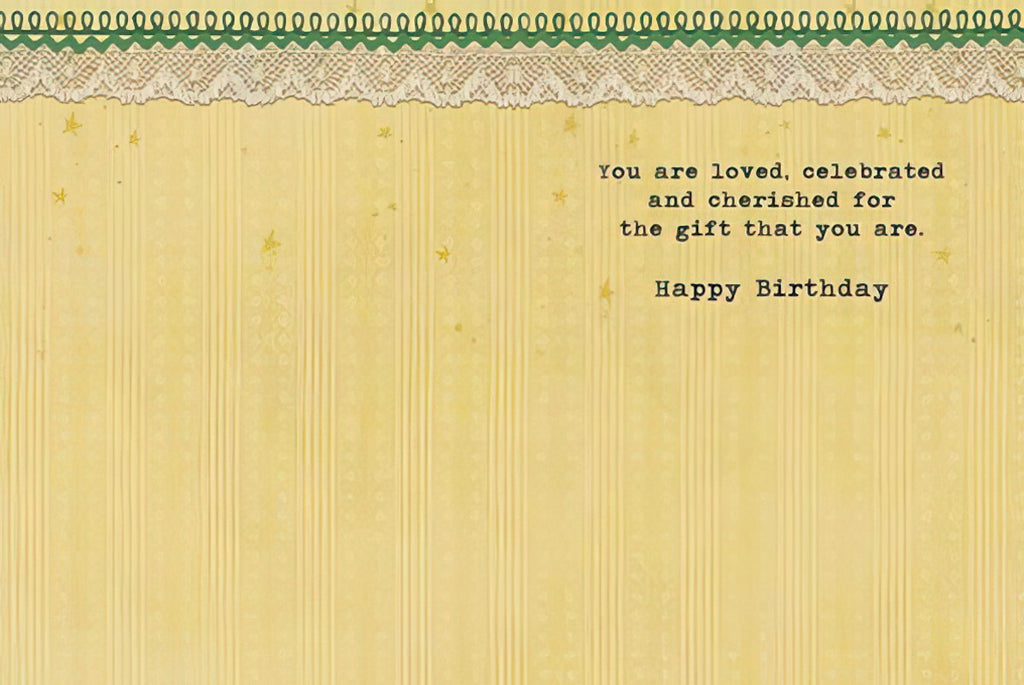 Inside of a heartfelt birthday card with a yellow striped background and decorative lace trim, displaying the message: 'You are loved, celebrated and cherished for the gift that you are. Happy Birthday.'