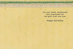 Inside of a heartfelt birthday card with a yellow striped background and decorative lace trim, displaying the message: 'You are loved, celebrated and cherished for the gift that you are. Happy Birthday.'