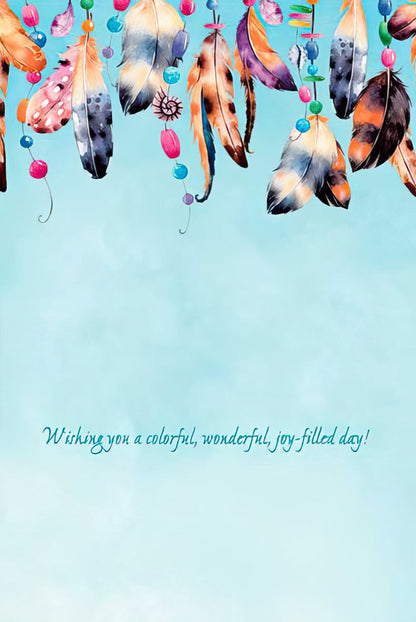 Inside of a greeting card with vibrant watercolor feathers, colorful beads, and 'Wishing you a colorful, wonderful, joy-filled day!' on a blue background.