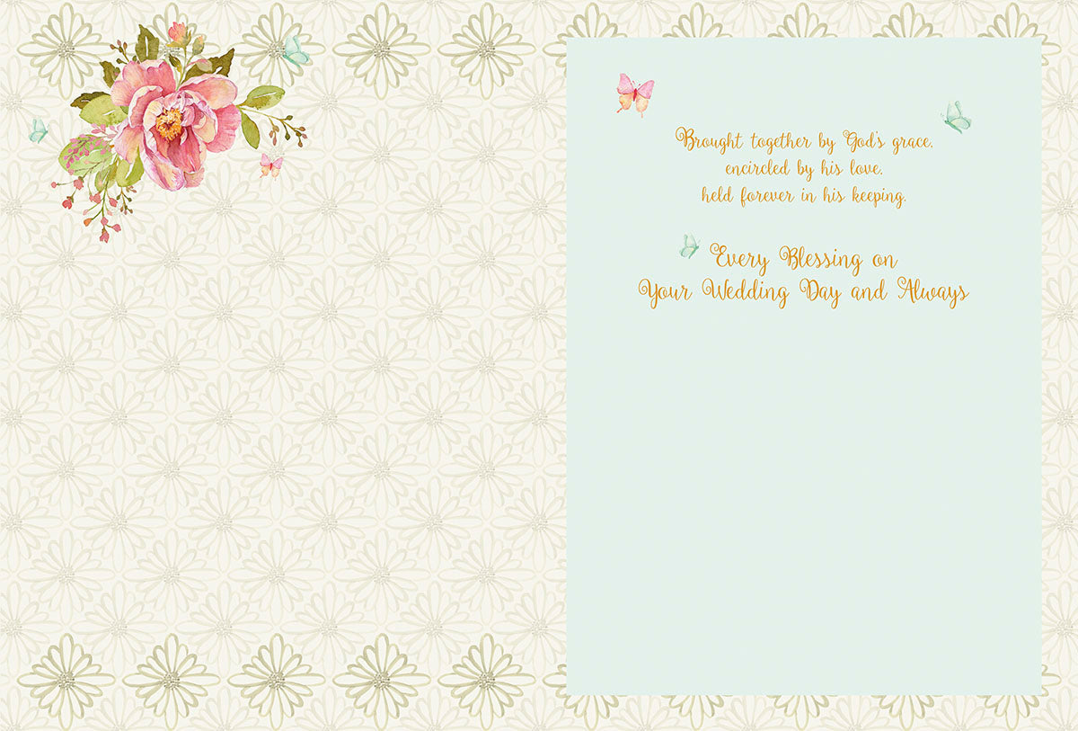 Inside a Christian bridal card with delicate floral accents and the message 'Brought together by God's grace... Every Blessing on Your Wedding Day and Always' offering best wishes for a blessed marriage.