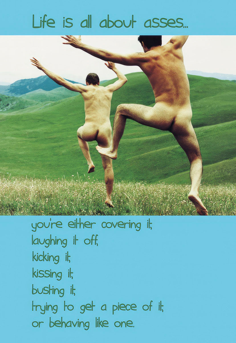 Humorous birthday greeting card featuring two nude men joyfully leaping in a grassy field under a blue sky, with text on the front: 'Life is all about asses... you're either covering it; laughing it off; kicking it; kissing it; busting it; trying to get a piece of it; or behaving like one.' A funny card for him or a friend.