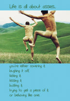 Humorous birthday greeting card featuring two nude men joyfully leaping in a grassy field under a blue sky, with text on the front: 'Life is all about asses... you're either covering it; laughing it off; kicking it; kissing it; busting it; trying to get a piece of it; or behaving like one.' A funny card for him or a friend.