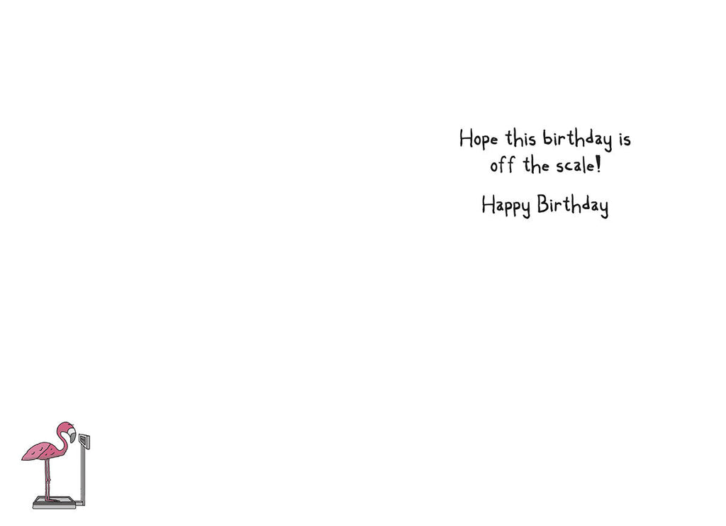 Inside of a funny birthday card, displaying the handwritten message "Hope this birthday is off the scale! Happy Birthday". A small, charming illustration of a pink flamingo standing on a weight scale is visible in the bottom left corner, reinforcing the card's witty theme.