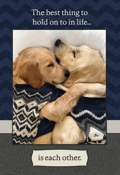 Anniversary card front: Two Golden Retriever dogs in sweaters snuggling, with the text 'The best thing to hold on to in life... is each other.'