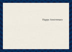 Inside of a thoughtful anniversary greeting card, subtly textured, with elegant black text reading 'Happy Anniversary' centered on the right side.