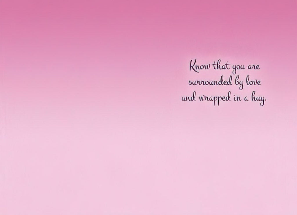 Inside of a greeting card with a gentle pink gradient background. Elegant script text reads 'Know that you are surrounded by love and wrapped in a hug.'.