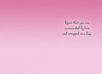 Inside of a greeting card with a gentle pink gradient background. Elegant script text reads 'Know that you are surrounded by love and wrapped in a hug.'.