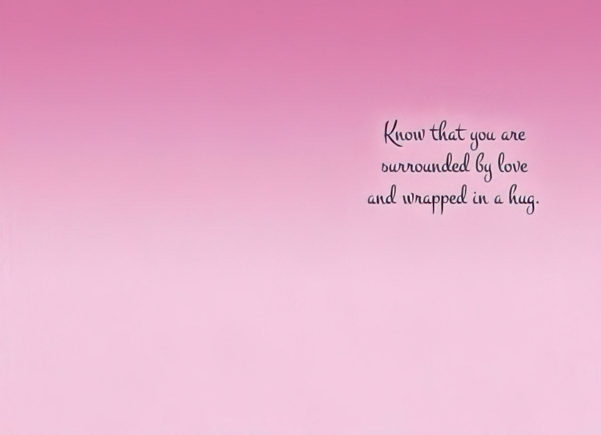 Inside of a greeting card with a gentle pink gradient background. Elegant script text reads 'Know that you are surrounded by love and wrapped in a hug.'.
