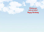 Inside of a light blue greeting card with white clouds, featuring the red text 'Wishing you miles of smiles! Happy Birthday' for a cheerful message.