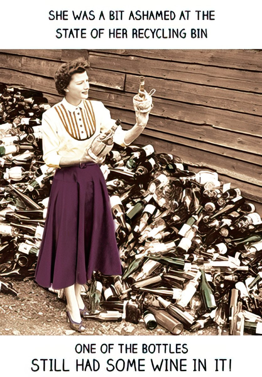 Funny greeting card front featuring a retro woman in a purple skirt and striped shirt, holding a wine bottle amidst a large pile of empty bottles. Text reads: 'SHE WAS A BIT ASHAMED AT THE STATE OF HER RECYCLING BIN ONE OF THE BOTTLES STILL HAD SOME WINE IN IT!'. Perfect humor for a woman's special day.