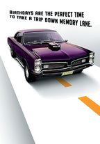 Front of a classic muscle car birthday card featuring a glossy purple vintage Pontiac GTO on a highway, with text 'Birthdays are the perfect time to take a trip down memory lane'.