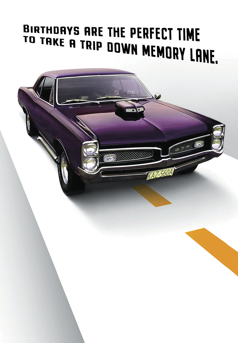 Front of a funny birthday greeting card for him, featuring a vibrant purple vintage muscle car on a highway, with text 'Birthdays are the perfect time to take a trip down memory lane.'