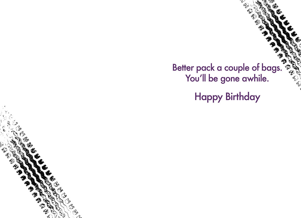 Inside of a humorous car-themed birthday card, showing tire tracks and the message 'Better pack a couple of bags. You'll be gone awhile. Happy Birthday.' for a friend.
