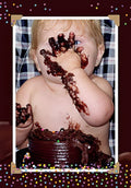 Adorable baby with blonde hair and blue eyes playfully covered in chocolate cake, celebrating a first birthday cake smash, a funny moment captured for a greeting card.