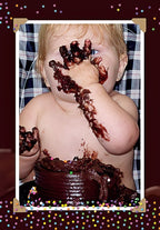 Adorable baby with blonde hair and blue eyes playfully covered in chocolate cake, celebrating a first birthday cake smash, a funny moment captured for a greeting card.