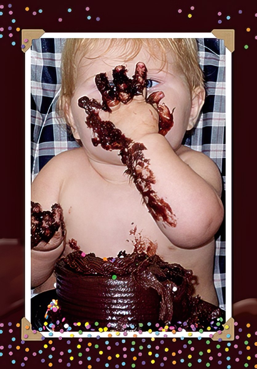 Adorable baby covered in chocolate cake, hands messy, celebrating first birthday with a joyful expression. Funny birthday card design.