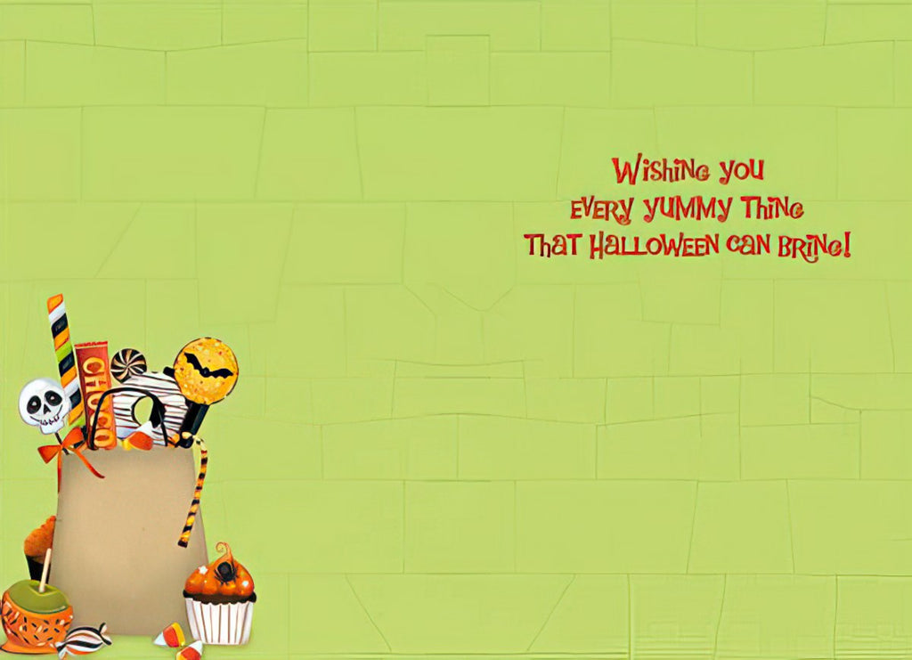 Inside of a fun greeting card with a light green background and Halloween candy illustration, featuring the message 'Wishing you EVERY Yummy Thing That Halloween Can Bring!' in playful red font.
