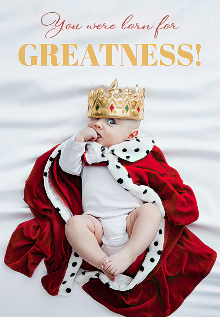 Adorable baby boy wearing a golden crown and red royal cape, lying on a white satin sheet, with elegant text 'You were born for GREATNESS!' Perfect encouraging card for a child's special day.