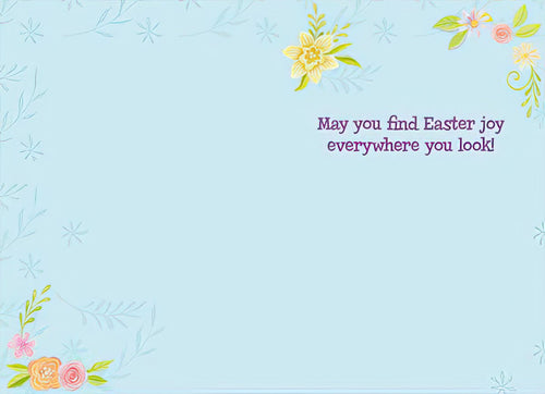 Inside of a light blue Easter greeting card with delicate floral accents in the corners and purple text reading 'May you find Easter joy everywhere you look!'