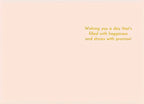 Inside view of a light peach greeting card with the message 'Wishing you a day that's filled with happiness and shines with promise!' in orange script.