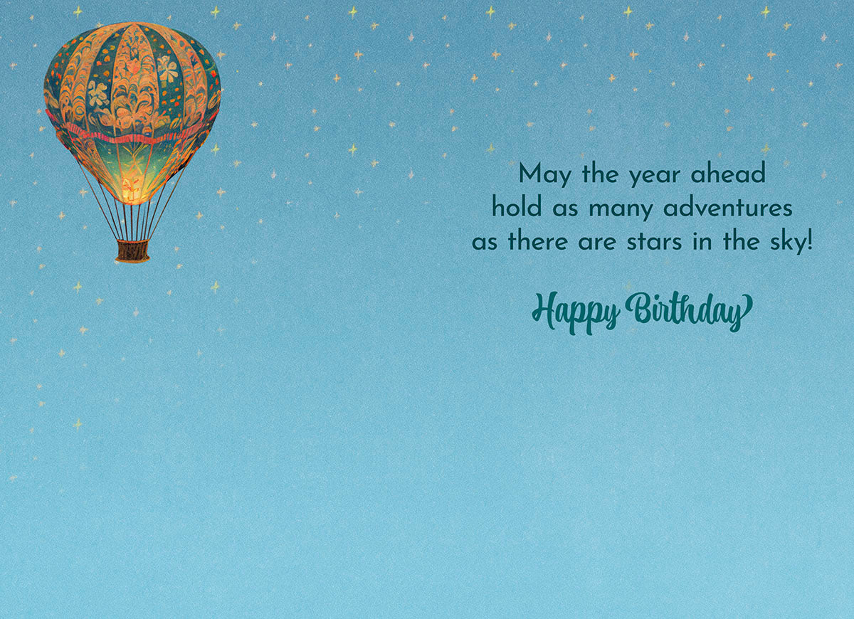 Interior of hot air balloon card: 'May the year ahead hold as many adventures as there are stars in the sky! Happy Birthday' on starry blue.