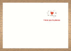 Open Valentine's Day card showing a small puzzle piece heart graphic and red text 'I love you to pieces' on a white inner page, framed by a subtle puzzle piece pattern border.