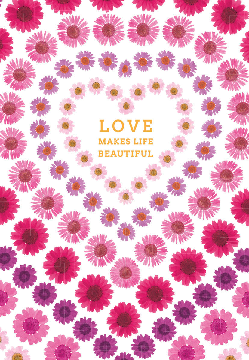 Front of a beautiful greeting card featuring a heart shape formed by concentric circles of vibrant pink and purple daisy flowers. The text 'LOVE MAKES LIFE BEAUTIFUL' is centered within the heart, on a white background.