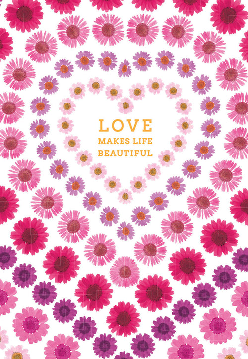 Front of a romantic Valentine's Day greeting card featuring a heart design made of vibrant pink and purple daisy-like flowers on a white background, with 'LOVE MAKES LIFE BEAUTIFUL' text in gold.