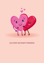 Front of a romantic Valentine's Day greeting card for spouses, featuring two cartoon hearts—one pink and smiling, one red with closed eyes—hugging on a light pink background. Text reads: 'you have my heart valentine'. Perfect for expressing deep affection to a partner.