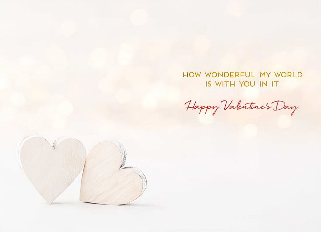 Inside of a romantic greeting card showing two rustic wooden hearts and heartfelt message: 'How wonderful my world is with you in it. Happy Valentine's Day.' for someone special.