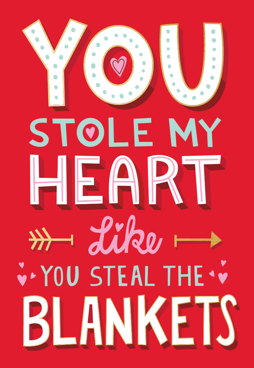 Front of a funny Valentine's Day greeting card for a spouse, featuring playful red, pink, and teal text that reads 'YOU STOLE MY HEART LIKE YOU STEAL THE BLANKETS' with decorative hearts and arrows on a vibrant red background.