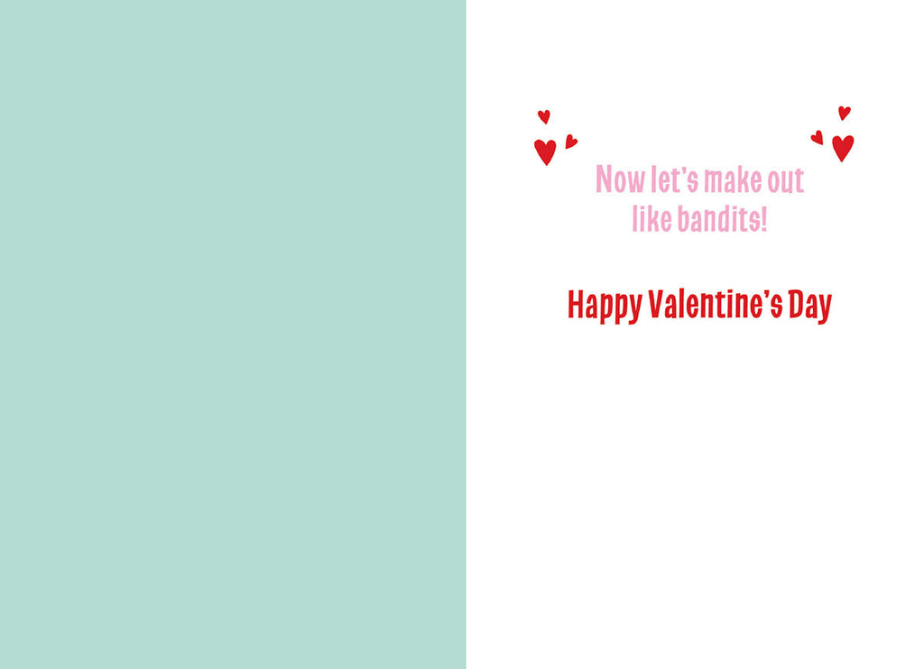 Inside view of a romantic and humorous greeting card, showing a light blue blank panel on the left and a white panel on the right with red text stating 'Now let's make out like bandits! Happy Valentine's Day' adorned with small hearts.